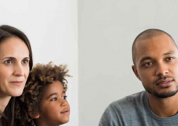 mom dad and child talking to a woman
