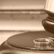judges gavel next to two wedding rings